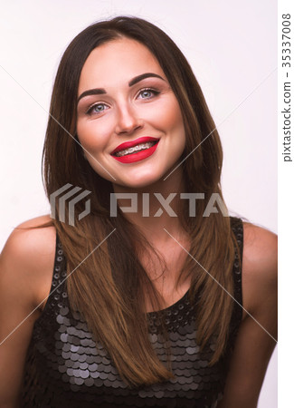 Portrait of smiling woman with tooth braces.  35337008