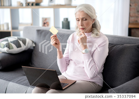 Senior woman doing online shopping in her 35337094