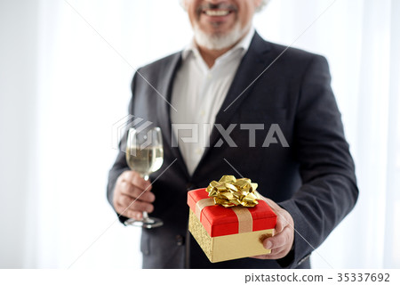 Happy mature male prepared gift for celebration 35337692
