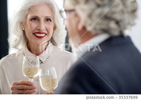Joyful mature married couple drinking champagne on 35337699