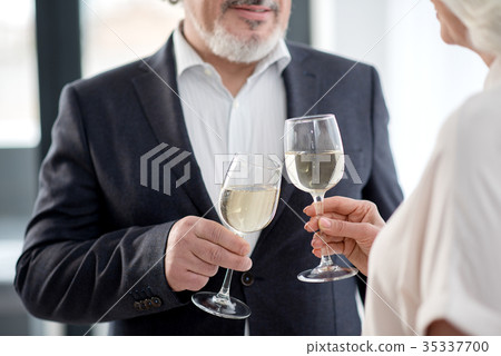 Happy senior married couple clinking glasses of Happy senior married couple clinking glasses of 35337700
