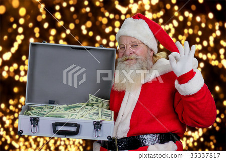 Santa Claus with full case of dollars. Santa Claus with full case of dollars. 35337817