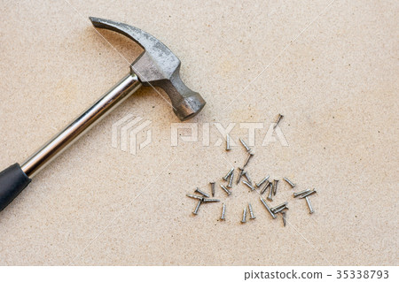 Hammer and nails on wood background Hammer and nails on wood background 35338793