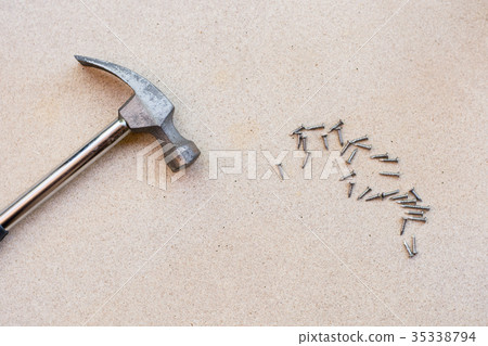 Hammer and nails on wood background Hammer and nails on wood background 35338794