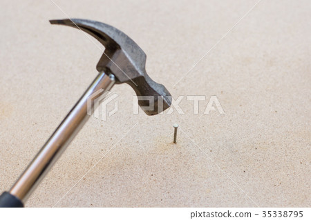 Hammer and nails on wood background 35338795