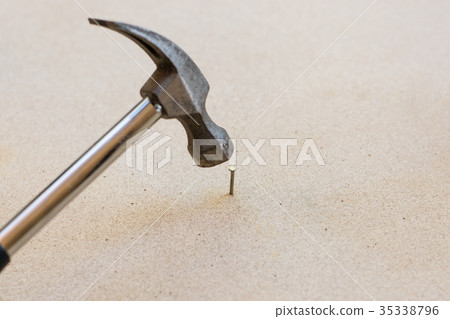 Hammer and nails on wood background 35338796