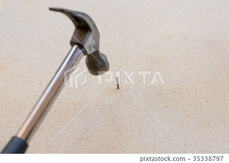 Hammer and nails on wood background 35338797