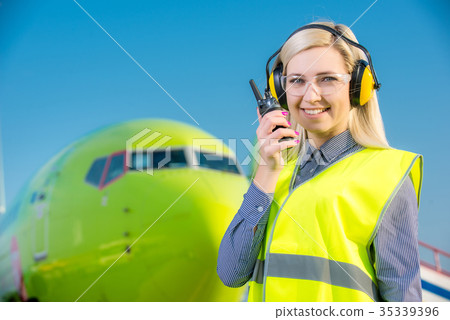 Airport worker with airplane on the background Airport worker with airplane on the background 35339396