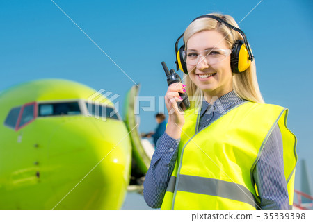 Airport worker with airplane on the background 35339398