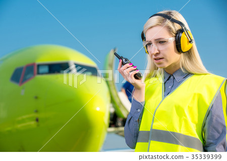 Airport worker with airplane on the background 35339399