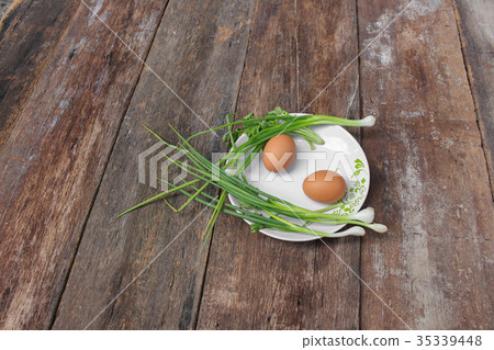 fresh chicken egg on a plate and onion in wooden fresh chicken egg on a plate and onion in wooden 35339448