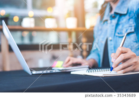 Woman hand works in a laptop computer Woman hand works in a laptop computer 35343689