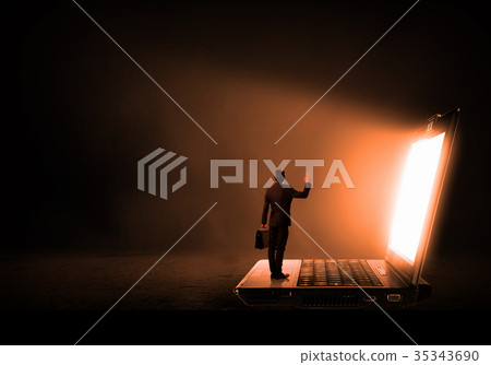 Man standing on big laptop Man standing on big laptop 35343690