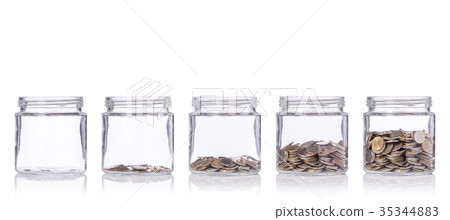 Thai coin (baht) in clear glass jar with different level from less to more. Studio shot isolated on white. Save money or investment financial for future concept 35344883