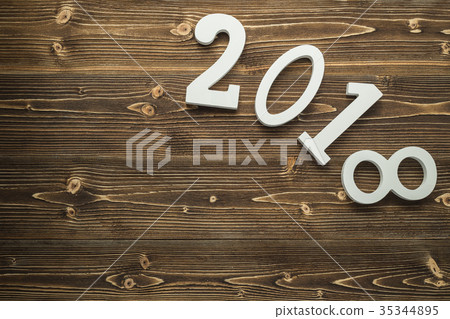Number 2018 for new year and holiday concept on brown wooden board. Top view with empty space for text and design Number 2018 for new year and holiday concept on brown wooden board. Top view with empty space for text and design 35344895