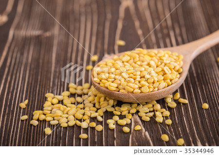 Mung beans in wooden spoon put on wooden plank background 35344946