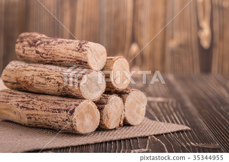 Thanaka wood on wooden plank background Thanaka wood on wooden plank background 35344955