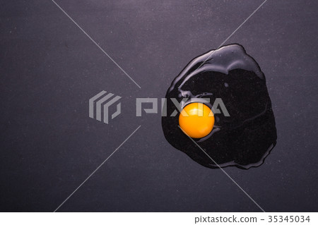 Broken eggs on the black stone ground. Free space for text and design. Top view 35345034