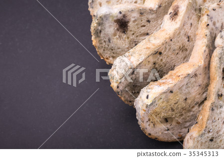 Mold on bread put on black stone table . Top view 35345313