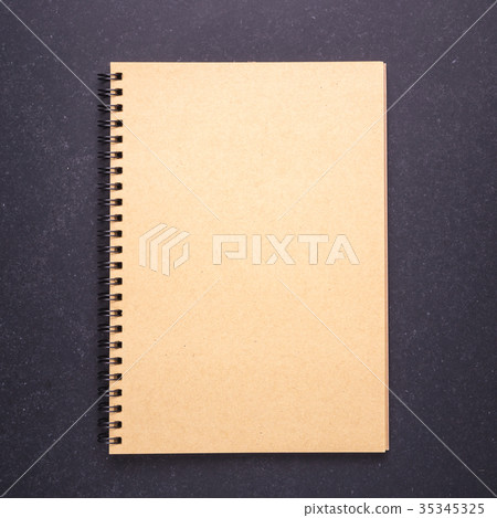 Notebook with blank empty cover on black stone table background. Top view Notebook with blank empty cover on black stone table background. Top view 35345325