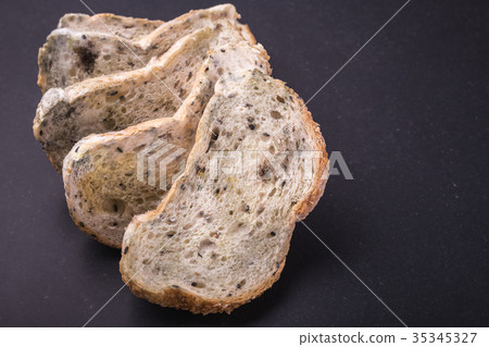 Mold on bread put on black stone table . Top view 35345327