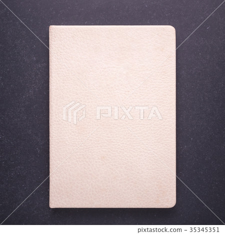 Notebook with blank empty cover on black stone table background. Top view 35345351