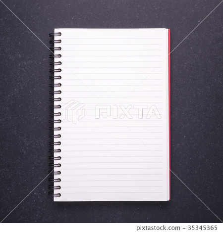 Notebook with blank empty cover on black stone table background. Top view 35345365