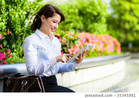 A woman watching a tablet 35345891