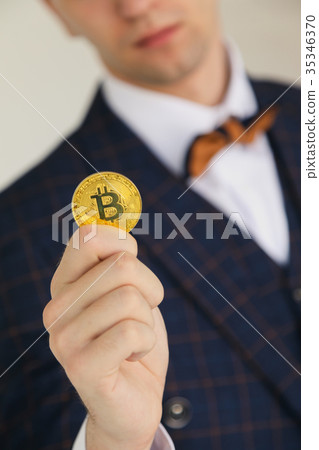 man holding bitcoin in his hand white back 35346370