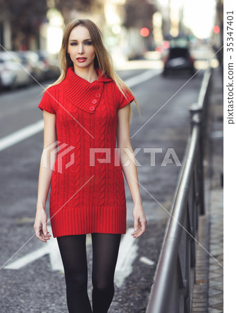 Young blonde woman walking in the street 35347401