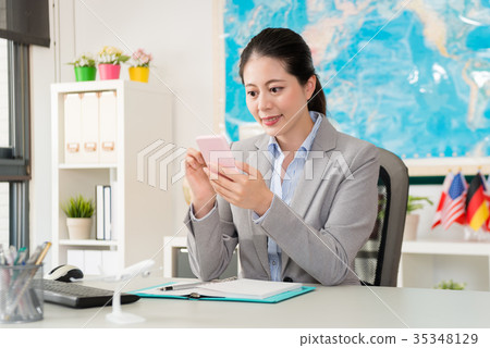 female travel agent manager sitting in office work 35348129