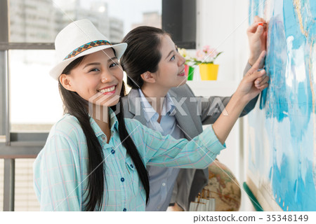 pretty female customer with travel agent woman pretty female customer with travel agent woman 35348149