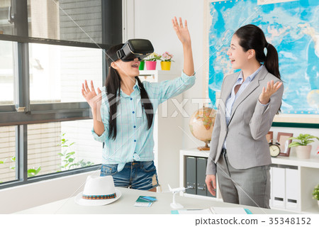 female traveler wearing virtual reality goggles female traveler wearing virtual reality goggles 35348152