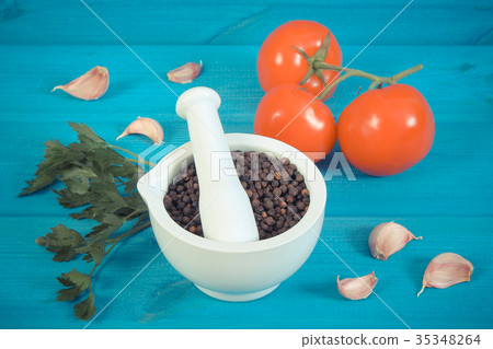Black pepper in mortar and vegetables on boards 35348264