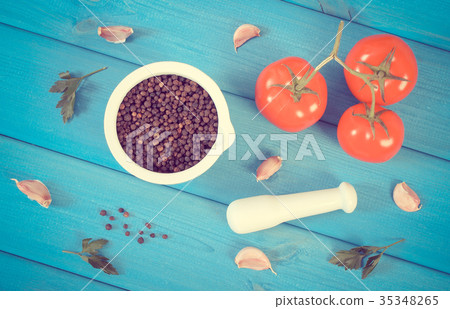 Black pepper in mortar and vegetables on boards 35348265