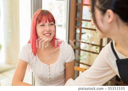 German woman ordering at a cafe 35351535