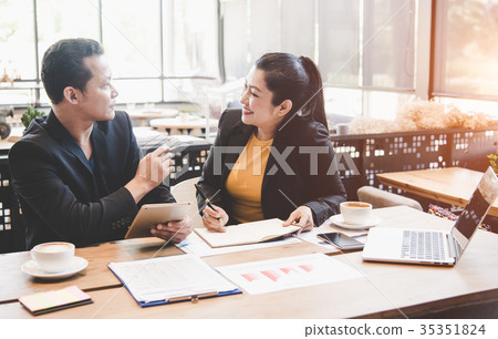 Boss with women secretary busy reviewing Boss with women secretary busy reviewing 35351824