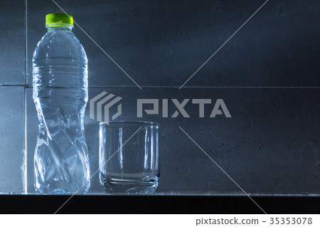 clear glass cup and full bottle of drinking water clear glass cup and full bottle of drinking water 35353078