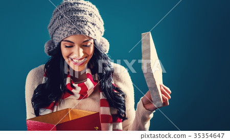 Happy young woman with Christmas present box Happy young woman with Christmas present box 35354647