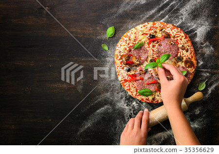 Girl hands making, decopating, preparing pizza 35356629
