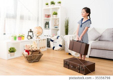 smiling female kid sailor carrying retro suitcase 35356798
