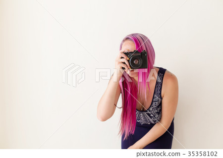 photographer girl with pink hair on a photo shoot 35358102