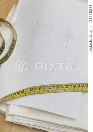 Sketch drawn on white paper with measuring tape 35358281