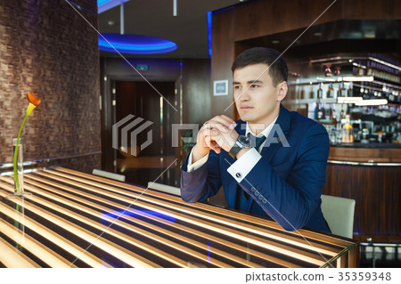 Groom sitting at the table in a bar and waiting 35359348