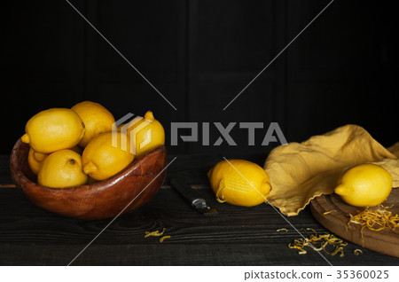 Fresh lemons and lemon zest on the table 35360025
