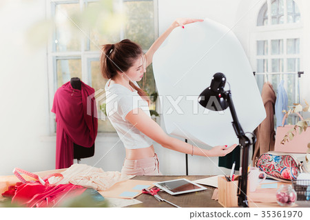 Fashion designers working in studio sitting on the Fashion designers working in studio sitting on the 35361970