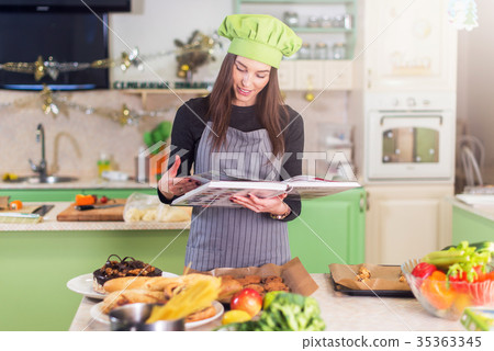 Pretty young female cook wearing Chef s hat 35363345