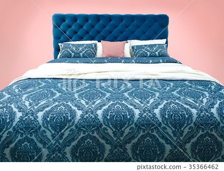 Blue bed furniture with patterned bed linen . Soft 35366462