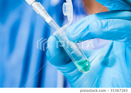 Scientist holding an eppendorf tube and pipette Scientist holding an eppendorf tube and pipette 35367265