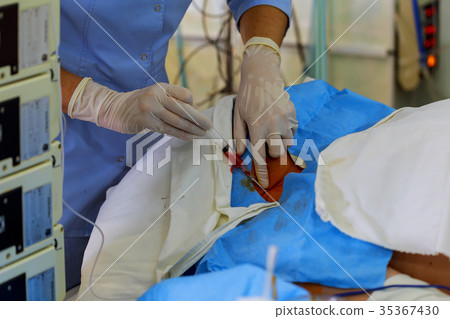 surgeon is preparing patients for surgery. 35367430